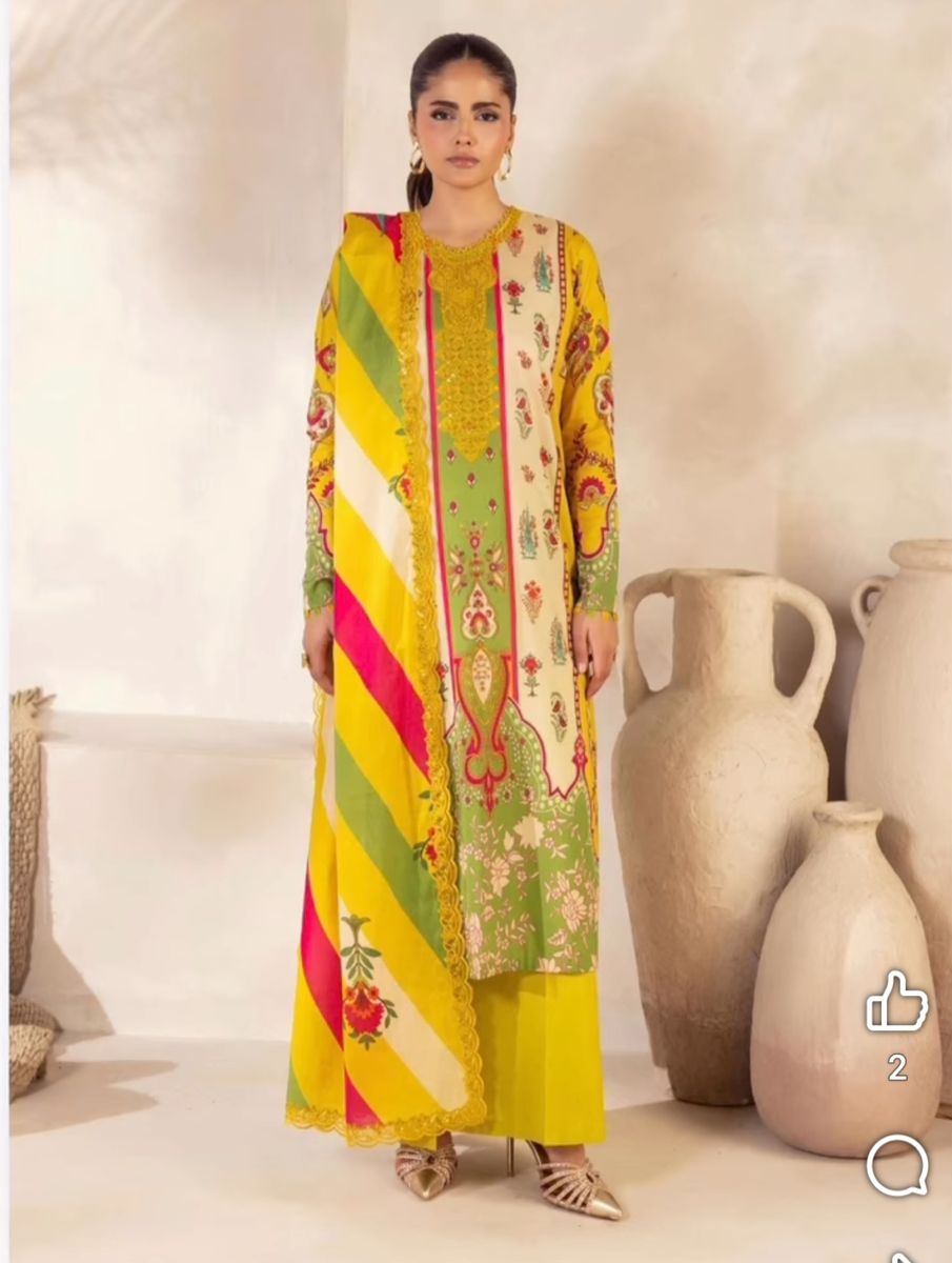 Model twirling in a cobalt blue embroidered suit with a fuchsia-lined dupatta
